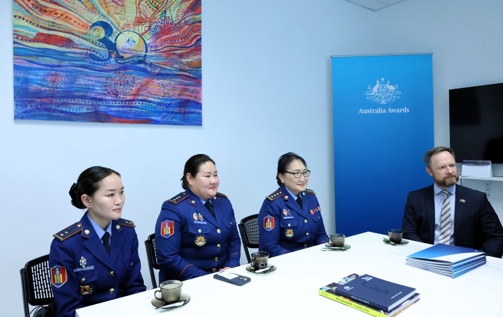 Alumni from the short course "Integrating Climate Change Adaptation and Disaster Risk Reductions to Reduce Vulnerability" sitting at the table with the delegates from Australia embassy and AAM office