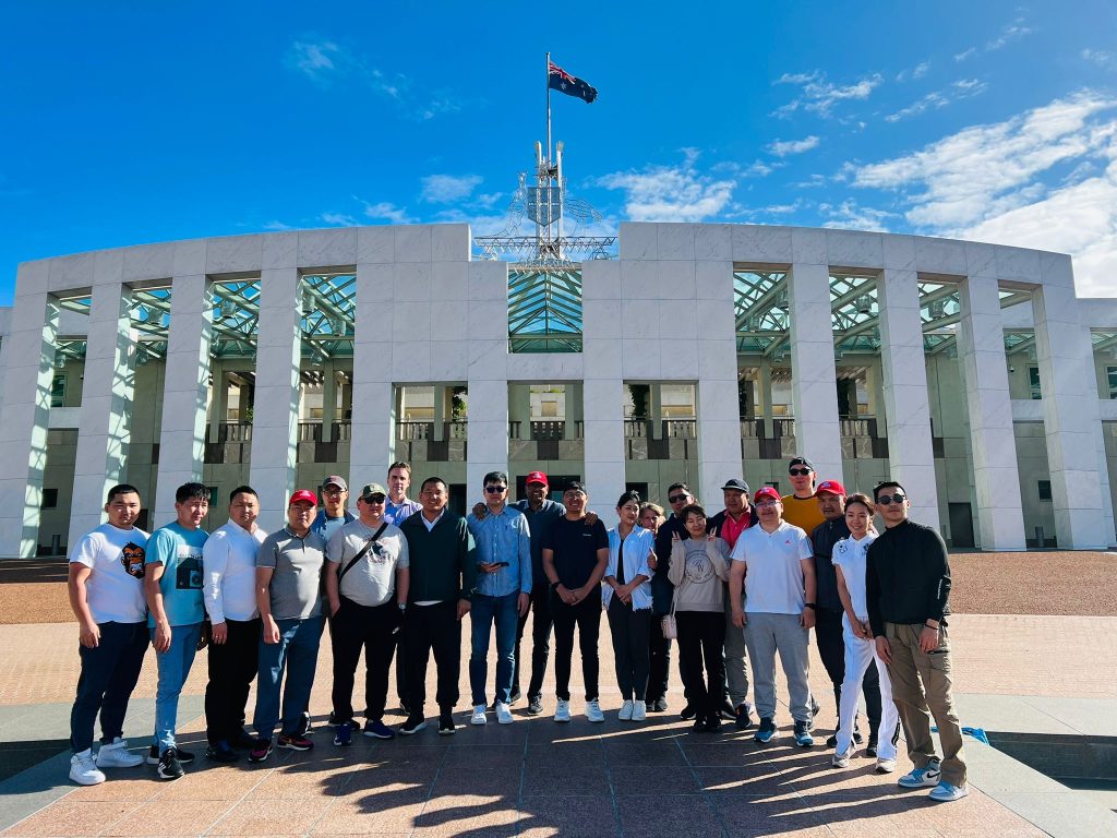 Ireedui (fourth from right) photographed with other Short Course participants in front of Parliament House in Canberra.